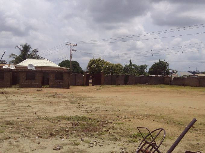 A plot of land with carcass school building in a secured compound with fence wall and a security gate facing the road measuring about 3,500m2.
