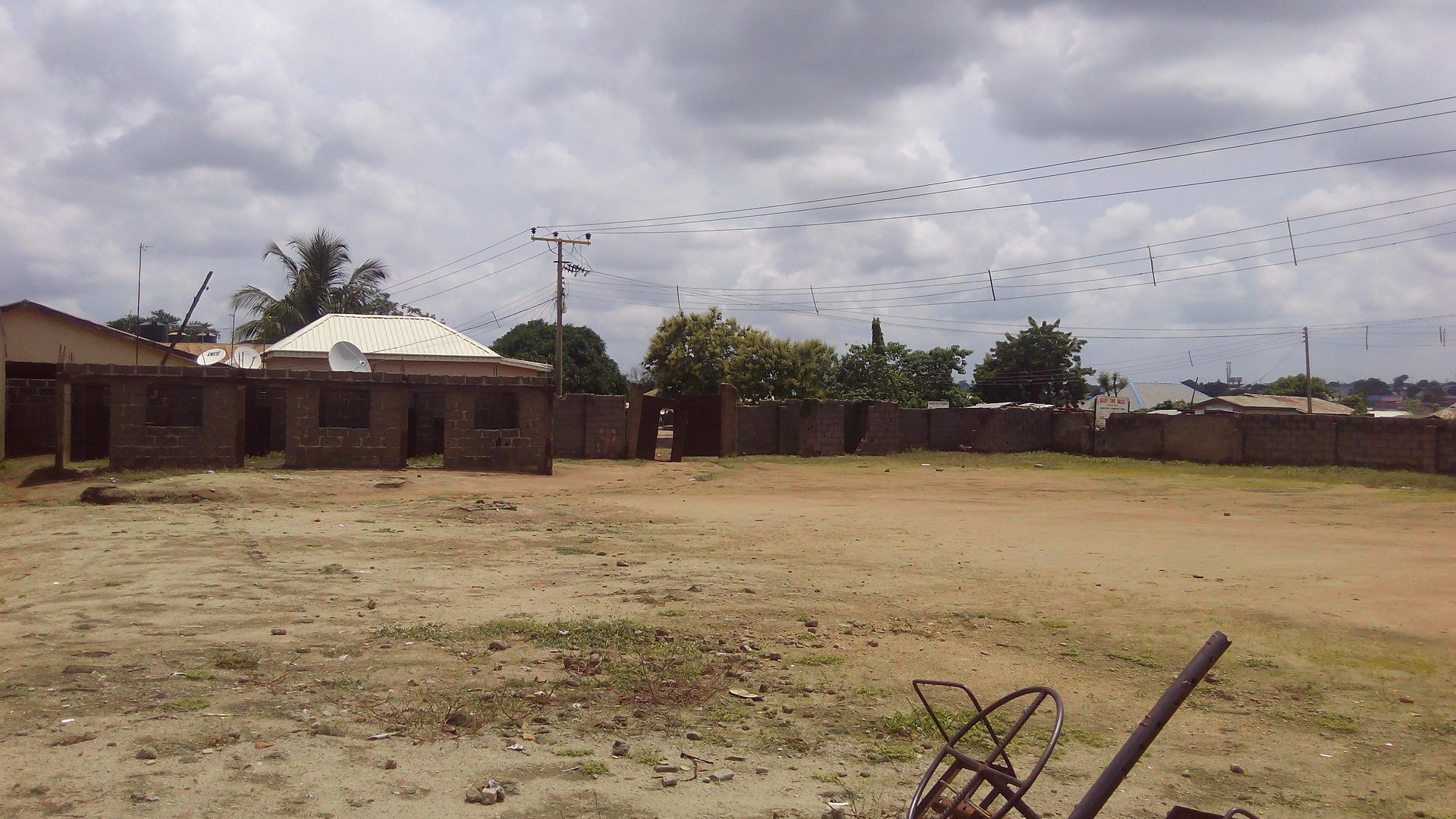 A plot of land with carcass school building in a secured compound with fence wall and a security gate facing the road measuring about 3,500m2.